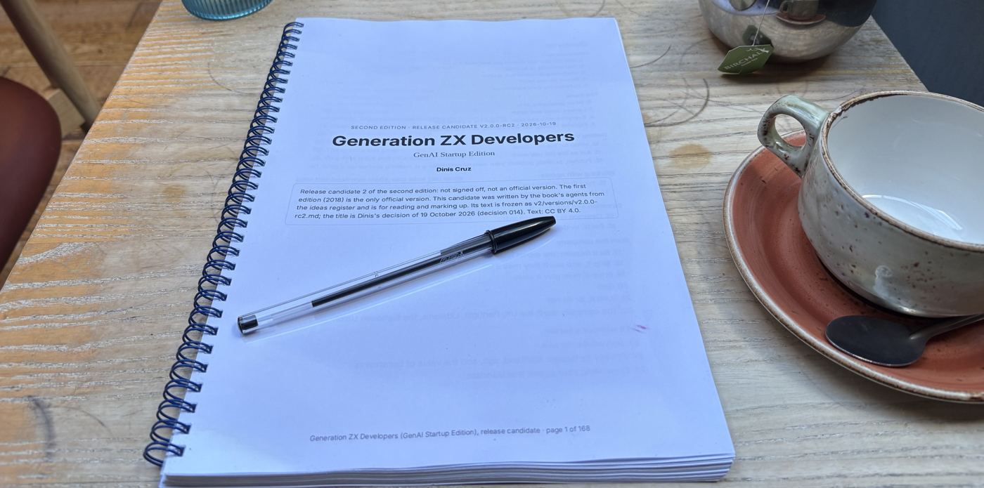 Release candidate 2 printed and spiral bound on a café table, with a pen on the title page, a teapot and an empty cup
